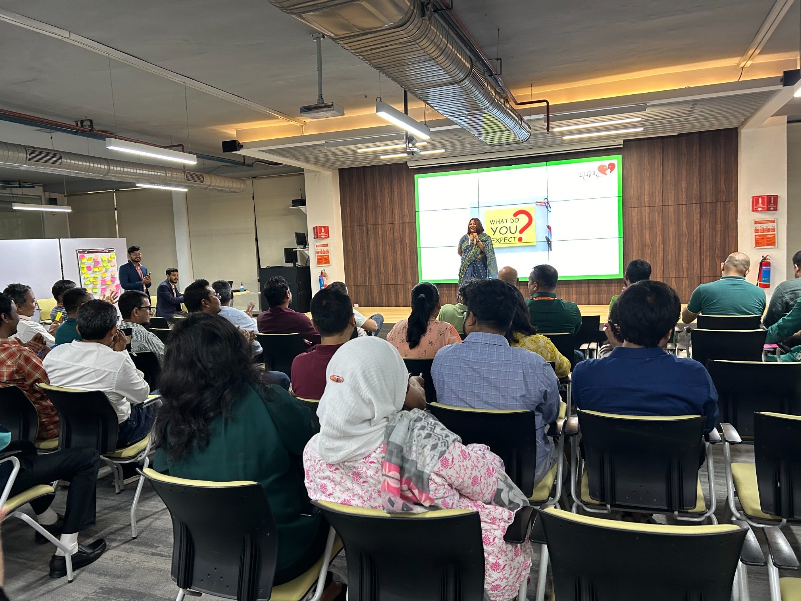 A Moner Bondhu wellbeing session with a seated audience at a partner organization